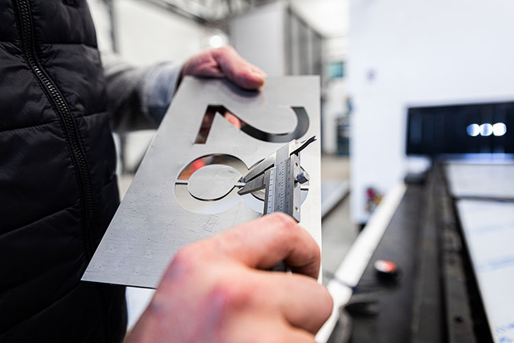 close up of mans hands inspecting laser cut of met 2023 11 27 05 12 13 utc