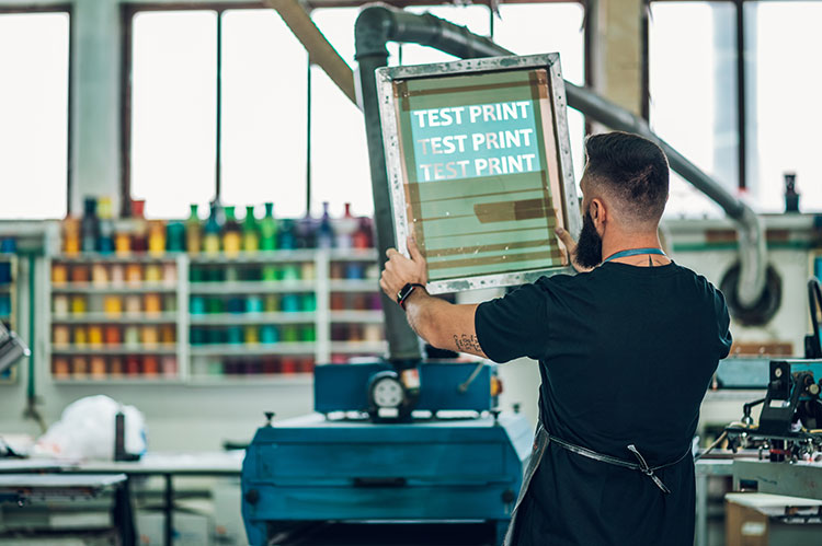 male worker preparing screen printing film in a wo 2023 11 27 05 23 14 utc